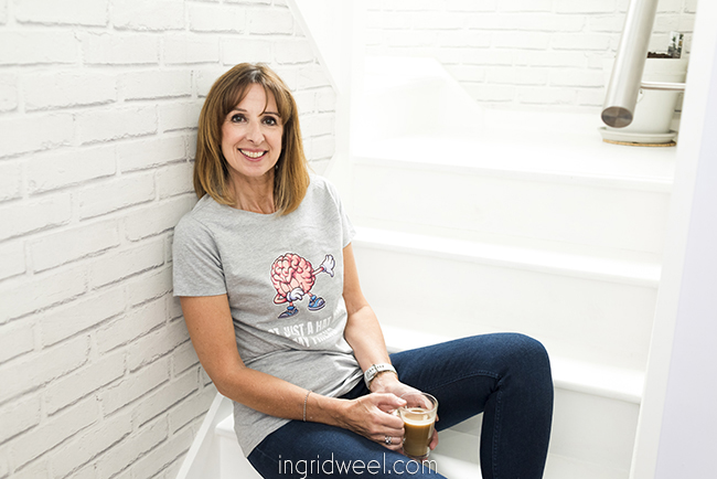 Relaxed photo of business woman on a white staircase smiling