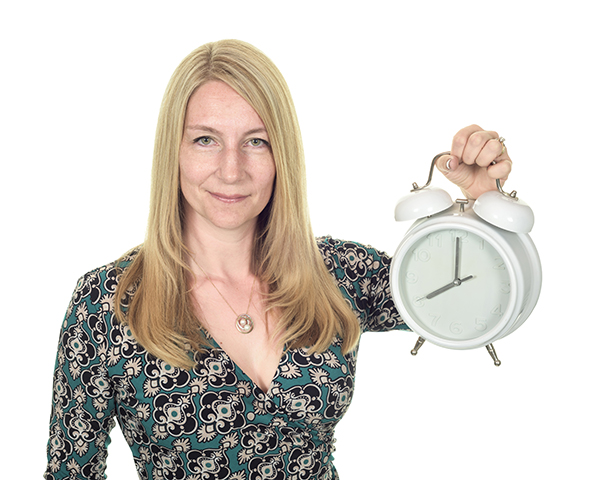 A promotional photo of a Doctor holding up a clock to illustrate insomnia stress
